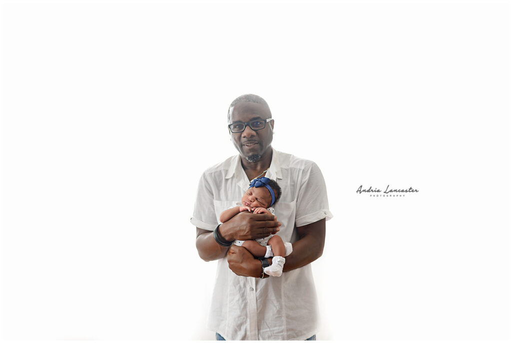 Tips for preparing for your newborn session dad holding newborn