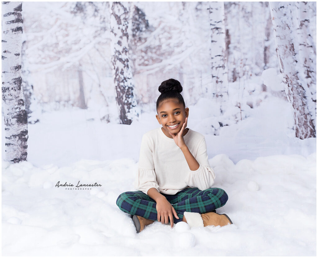 Child sitting in faux snow